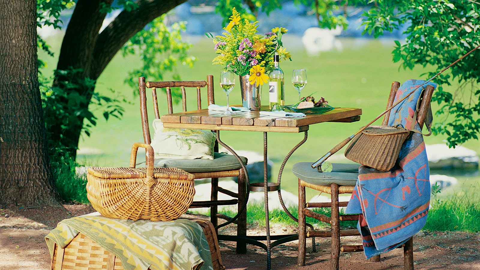 A table set outdoors next to a picnic basket at River Café